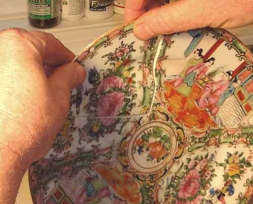 Professional restoration of an antique hand-painted porcelain plate