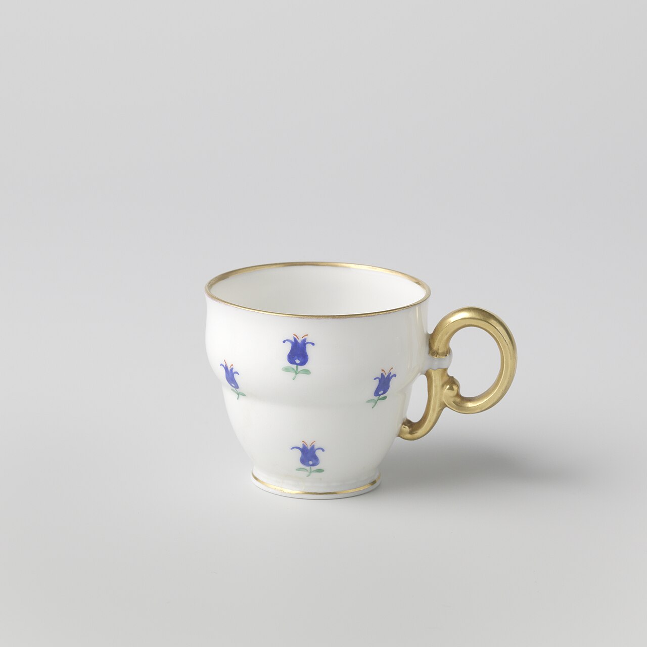 Antique Bohemian porcelain cup with blue floral decoration and gilded handle
