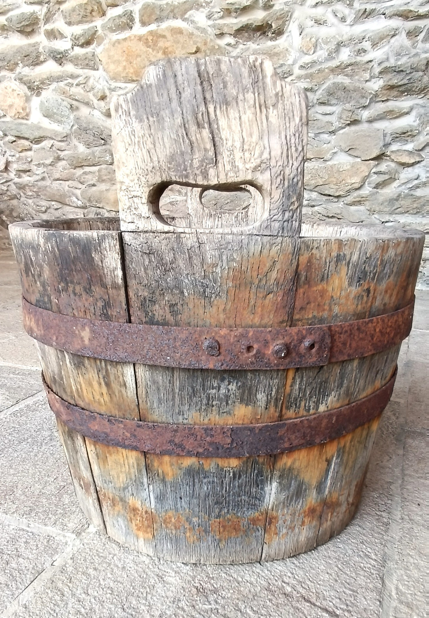 Rear view of antique Bulgarian Balkan coopered wooden vessel with hand-cut lug handle and riveted iron hoops, 19th century