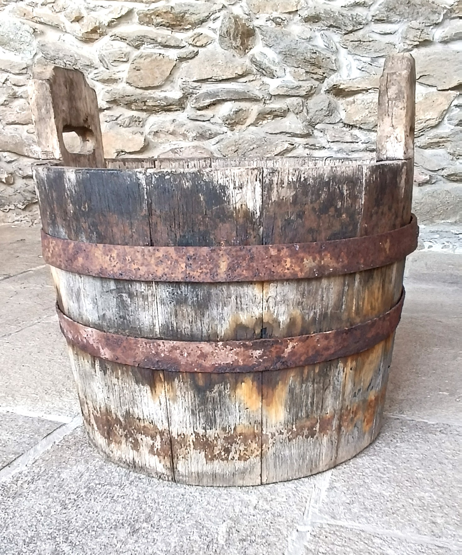 Side profile of antique Bulgarian Balkan coopered wooden vessel with two raised handles and aged riveted iron hoops, 19th century