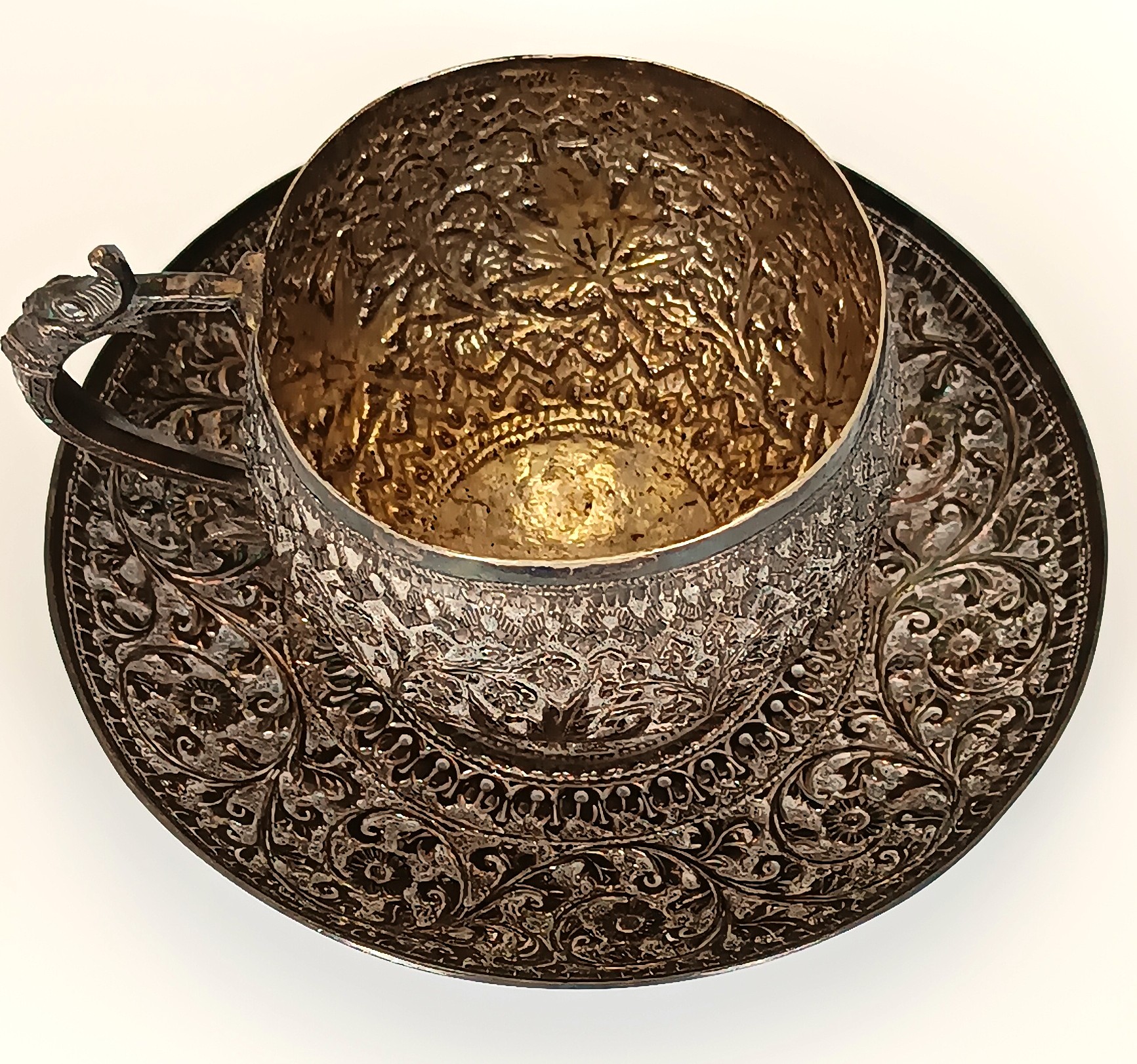 Top view of antique Kashmiri Anglo-Indian cup and saucer with dense floral arabesque decoration, circa 1900