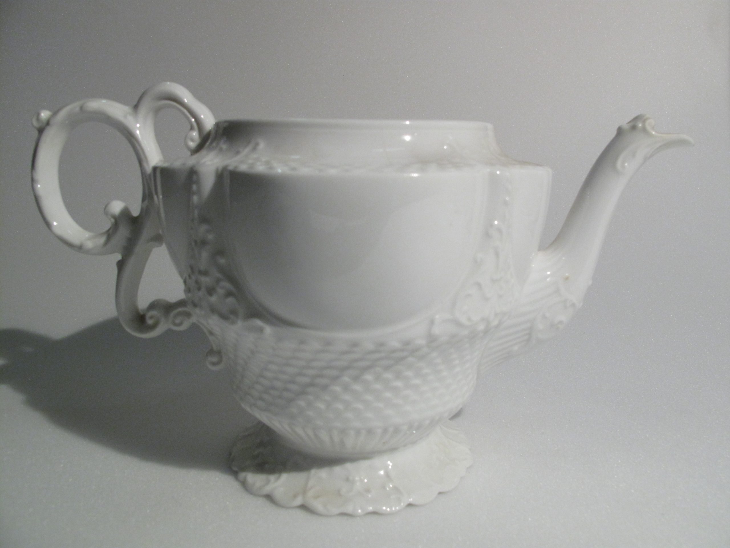 Antique White Aynsley Porcelain Teapot Antique white Aynsley porcelain teapot with moulded decoration and ornate handle