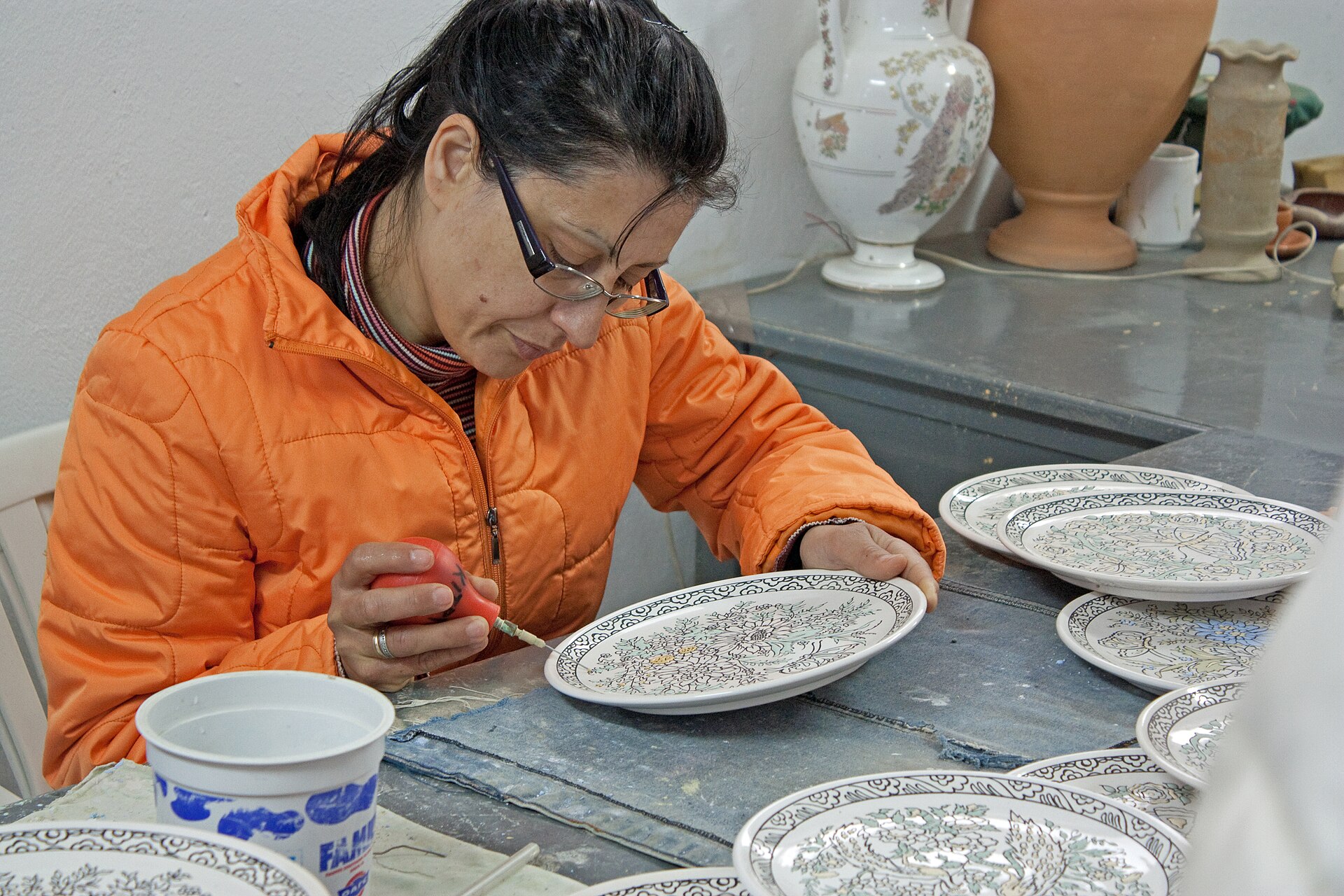 Greek pottery painting in Rhodes showing hand decoration of traditional ceramics