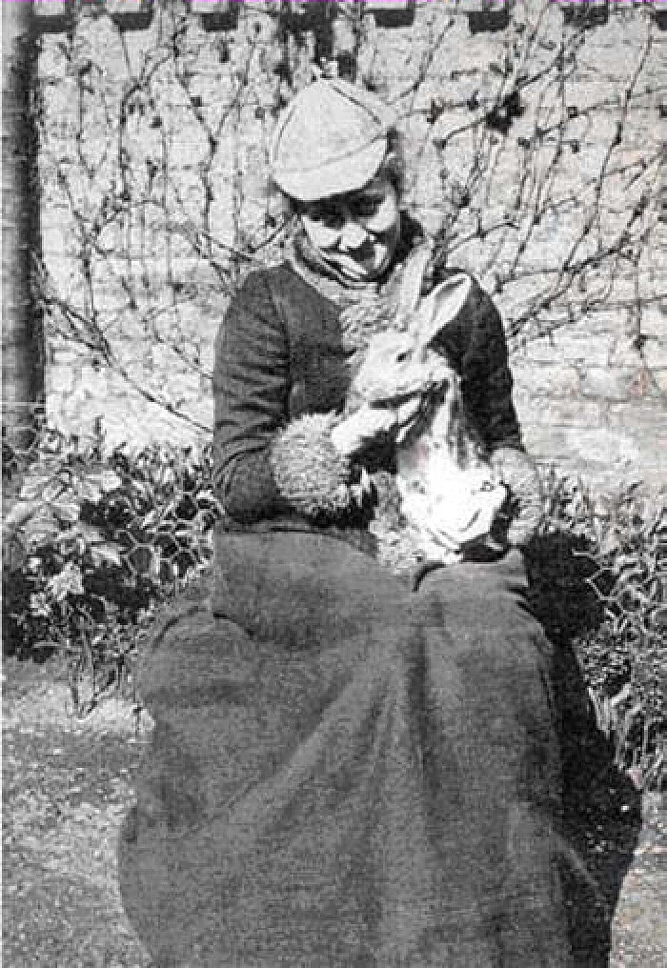 Historic Rabbit Photograph – Beatrix Potter Context Historic photograph of a woman holding a rabbit illustrating the natural history context behind Beatrix Potter's animal characters