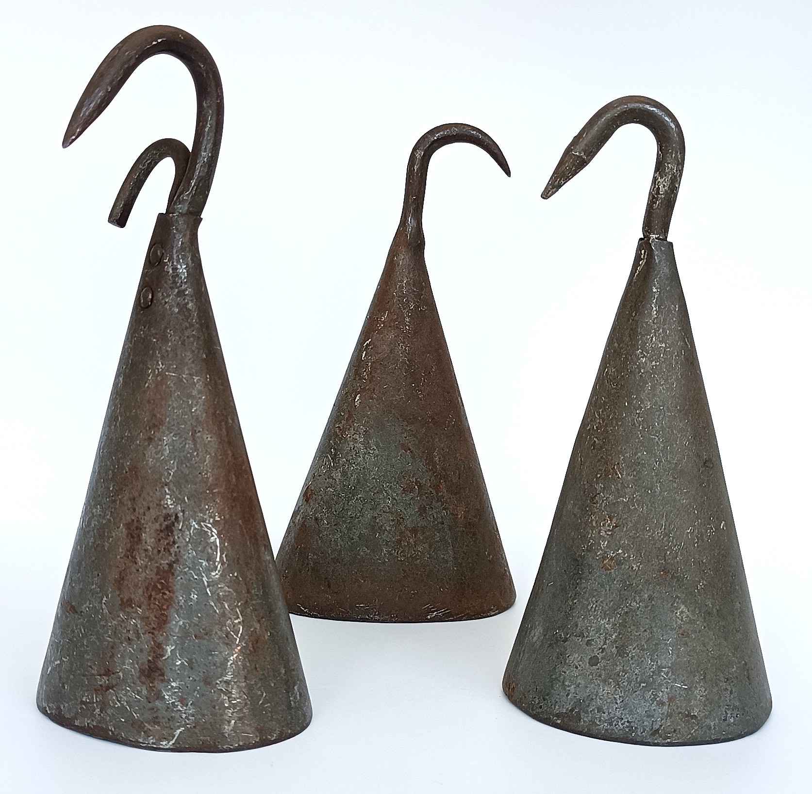 Three vintage forged iron butcher pig scraper bells with curved hooks