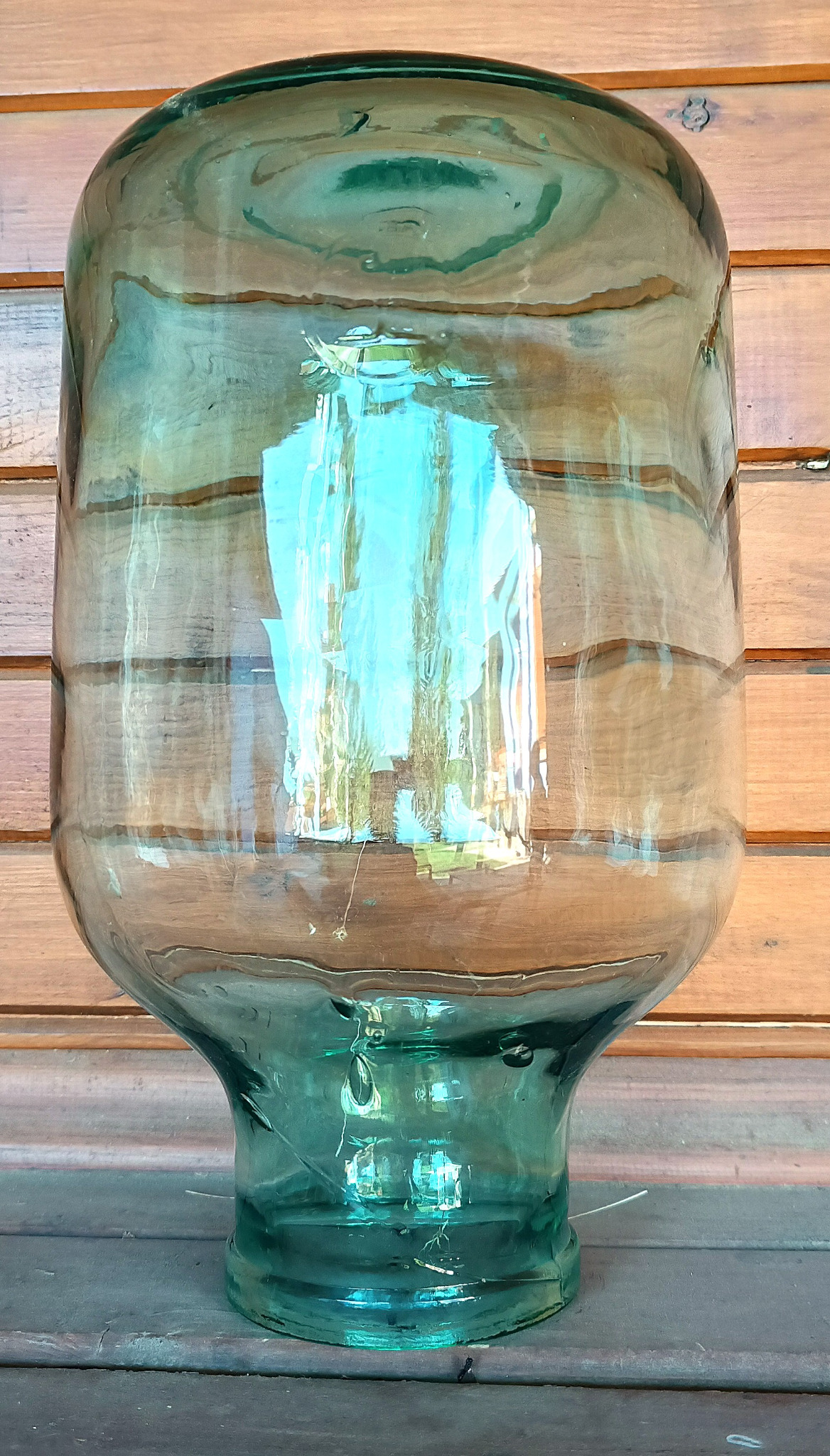 Base and lower body of vintage green glass 8-litre demijohn with thick blue-green glass