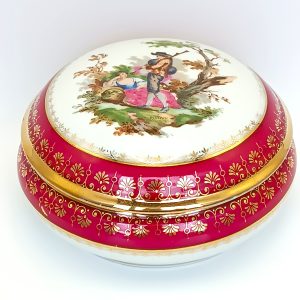 Vintage Limoges France porcelain box with a Watteau-style courting scene and gilded red border