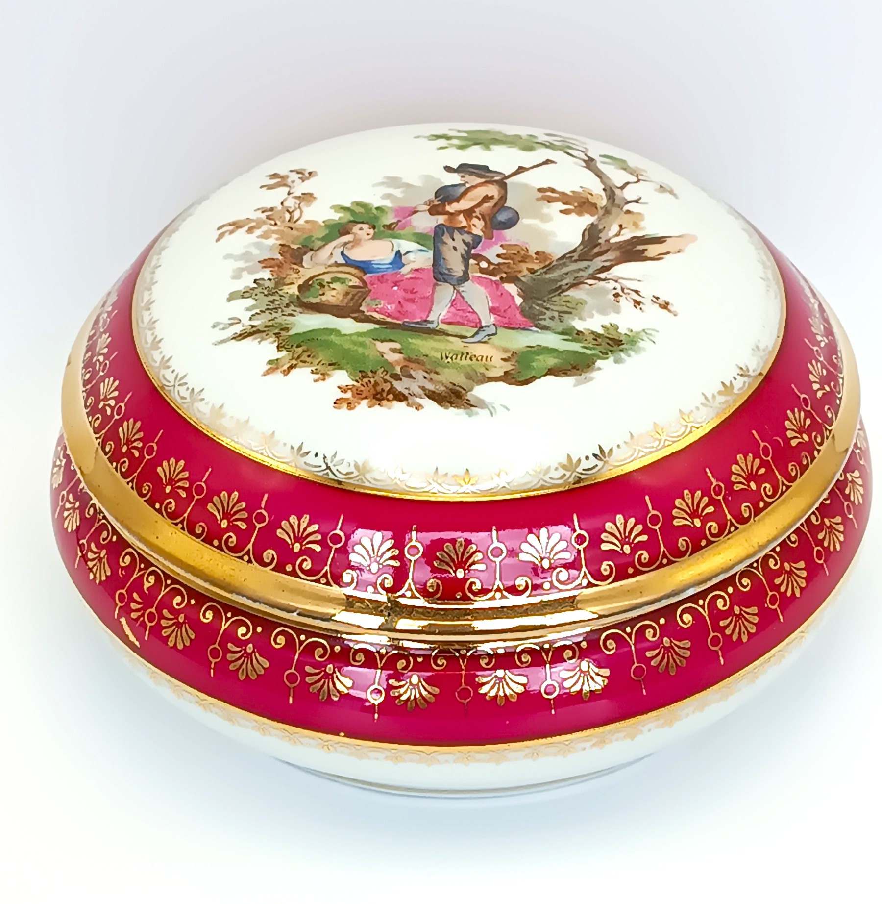 Vintage Limoges France porcelain box with a Watteau-style courting scene and gilded red border