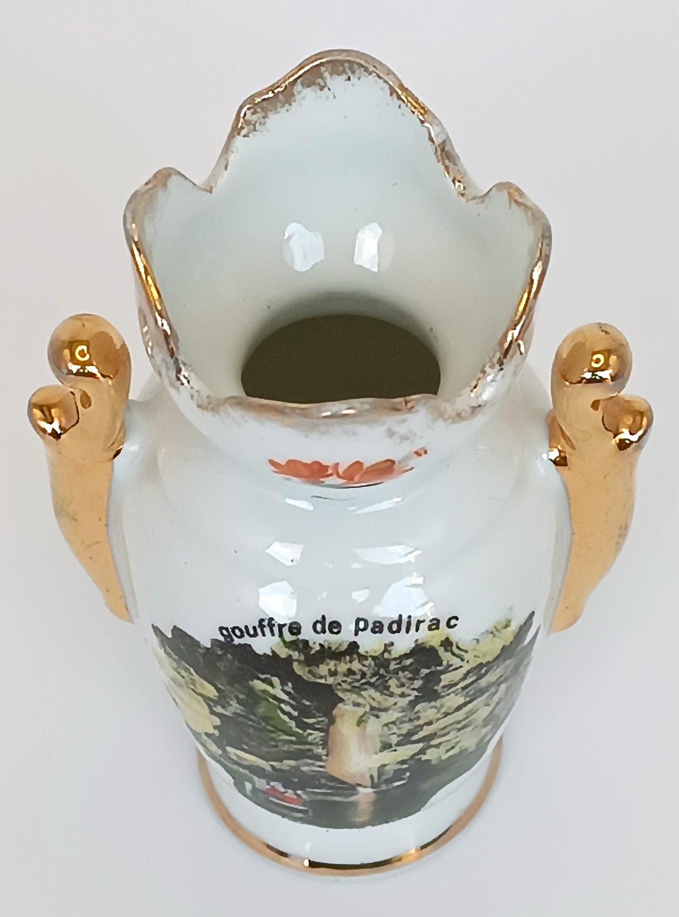 Vintage Limoges porcelain vase with gilt handles and floral decoration, top view