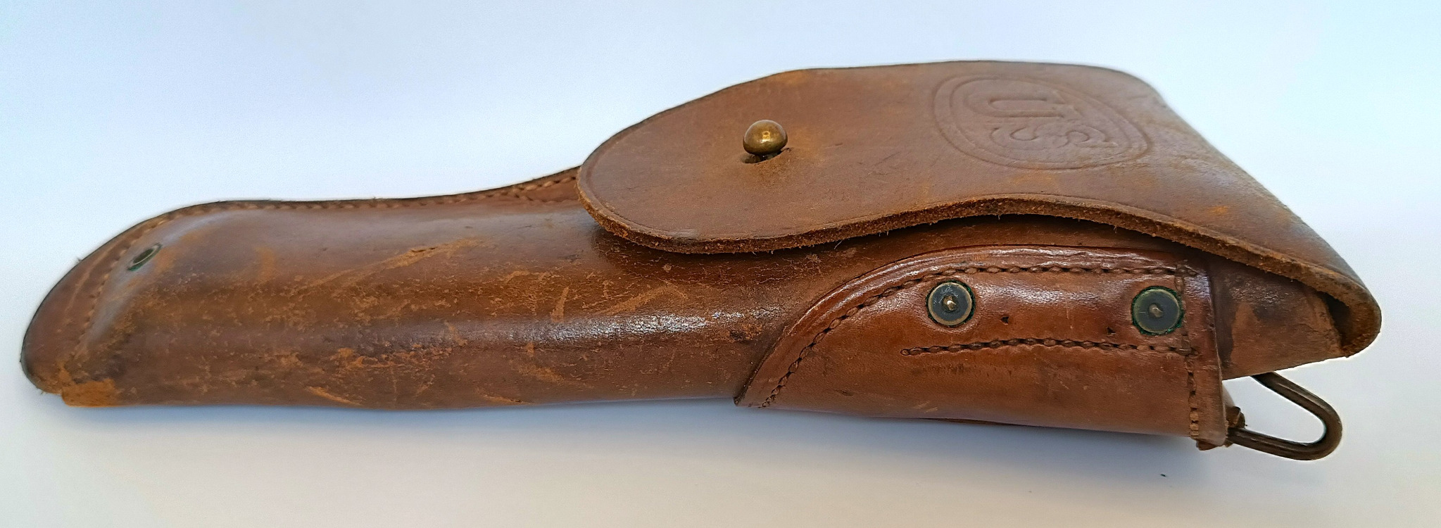 Side view of an original U.S. M1916 leather holster for Colt M1911/M1911A1 with embossed U.S. marking