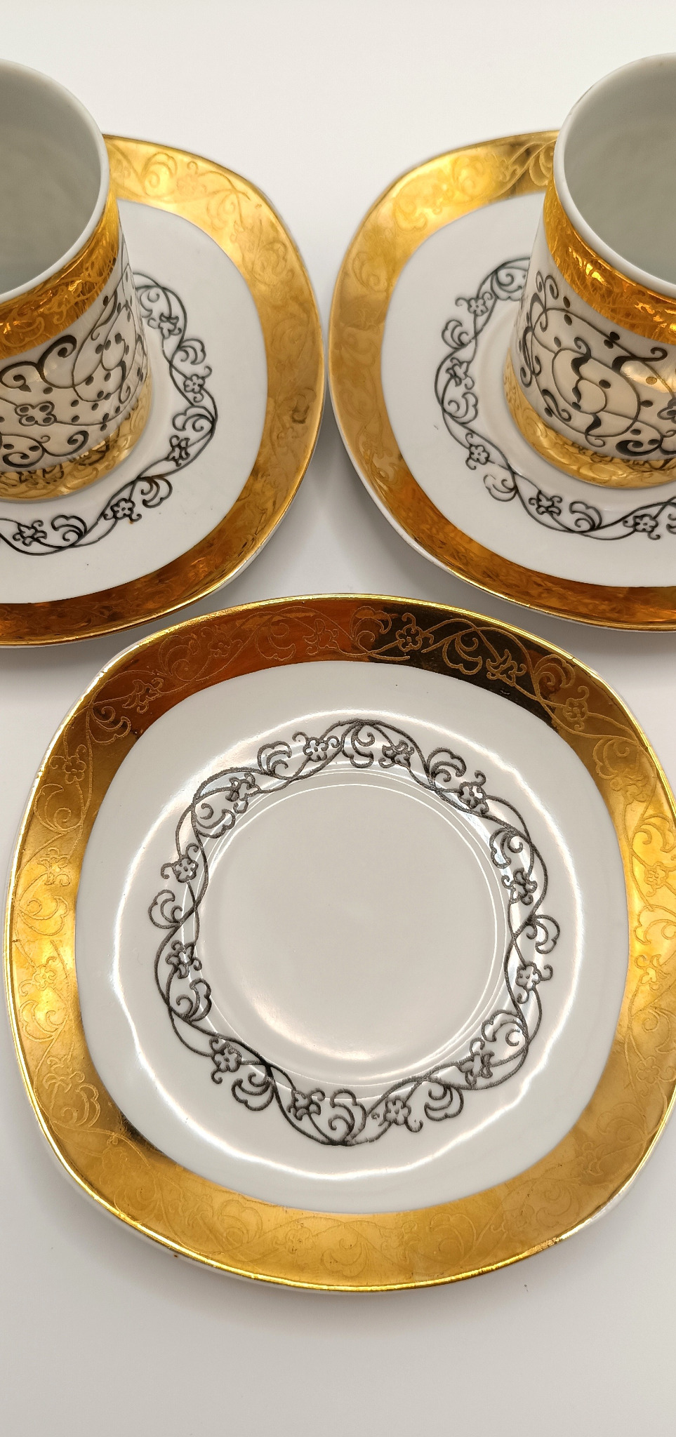 Detail of rare Bulgarian EAB bone china espresso set with 24K gold and black arabesque decoration