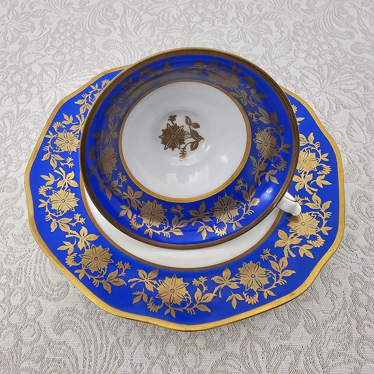 Vintage Seltmann Weiden Bavaria porcelain cup and saucer with cobalt blue panels, rich gold floral decoration and gilded rims