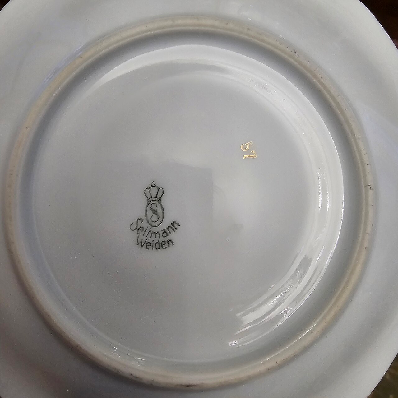 Seltmann Weiden porcelain backstamp with crowned S factory mark and gold number 57 on the underside of a plate