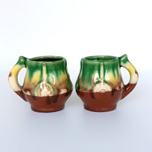 Pair of vintage Bulgarian glazed ceramic rakia cups in Troyan style with green, yellow, cream and brown decoration