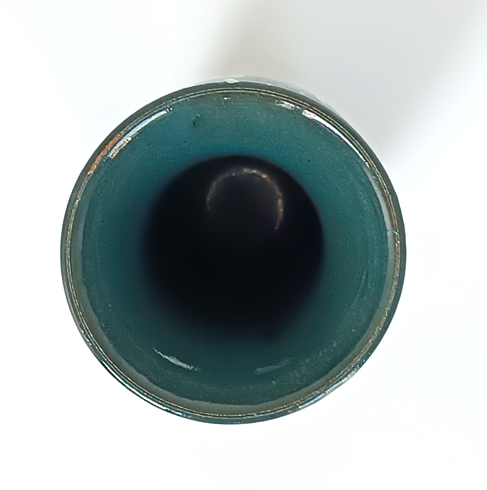Top view of a vintage ceramic vase showing the wide opening and dark green glazed interior