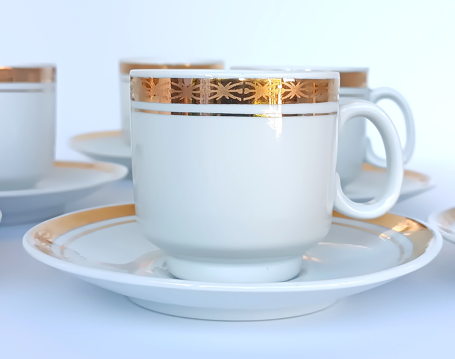 Vintage Bulgarian Kitka porcelain coffee cup and saucer with broad gold-tone decorative band and fine linear detail