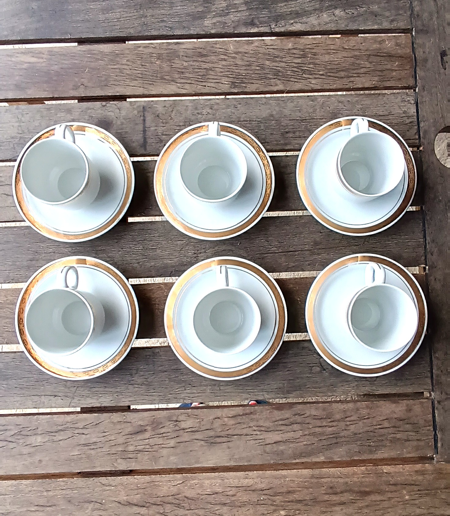 Vintage Bulgarian Kitka porcelain coffee set with six white cups and saucers decorated with gold-tone bands