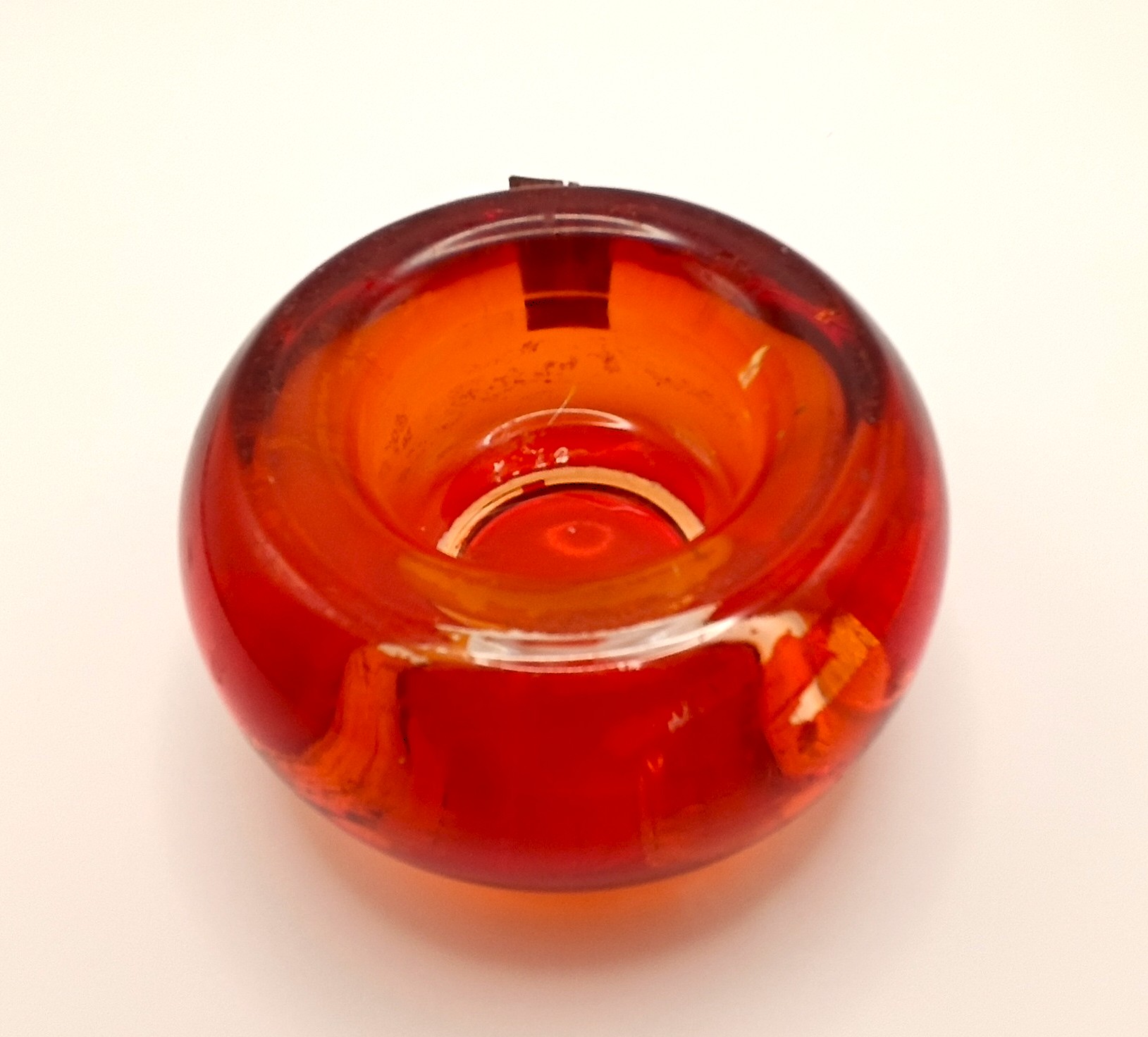 Interior view of a vintage LEONARDO orange art glass tealight candle holder