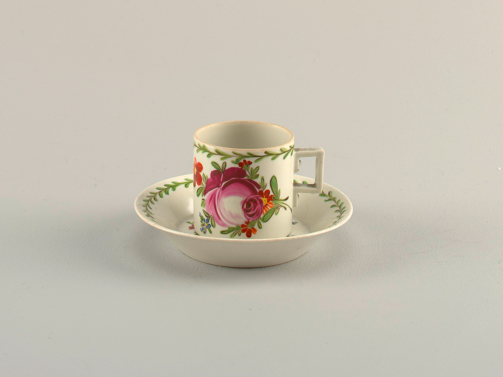 Wallendorf porcelain cup and saucer circa 1800 with hand-painted rose and geometric handle