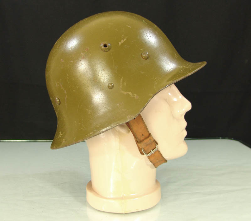 Bulgarian M36 steel helmet side profile with lower flared rim, ventilation fitting and leather chinstrap
