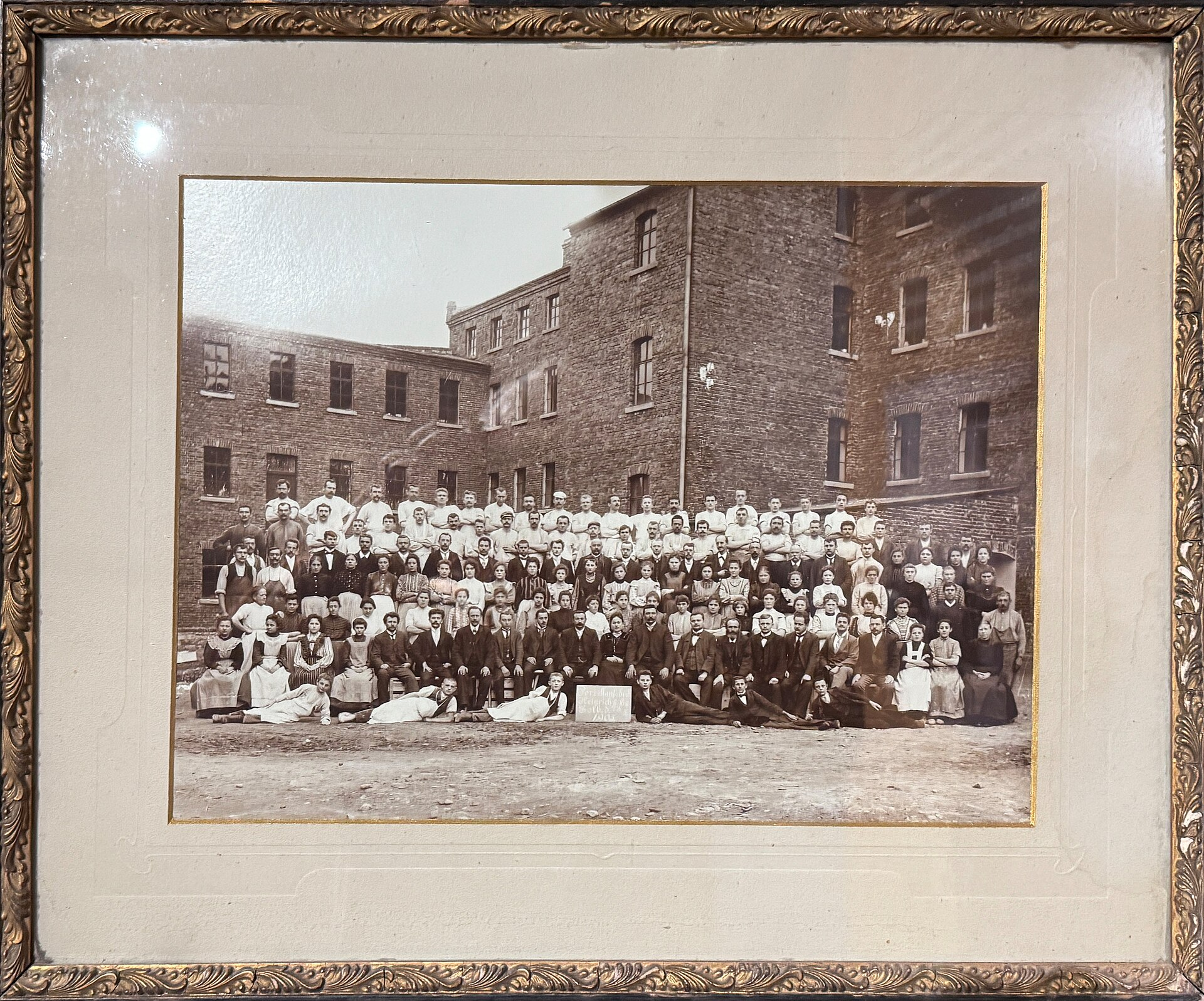 Historic group photograph of Heinrich and Co porcelain factory employees in Selb Bavaria circa 1905 outside the brick manufacturing buildings