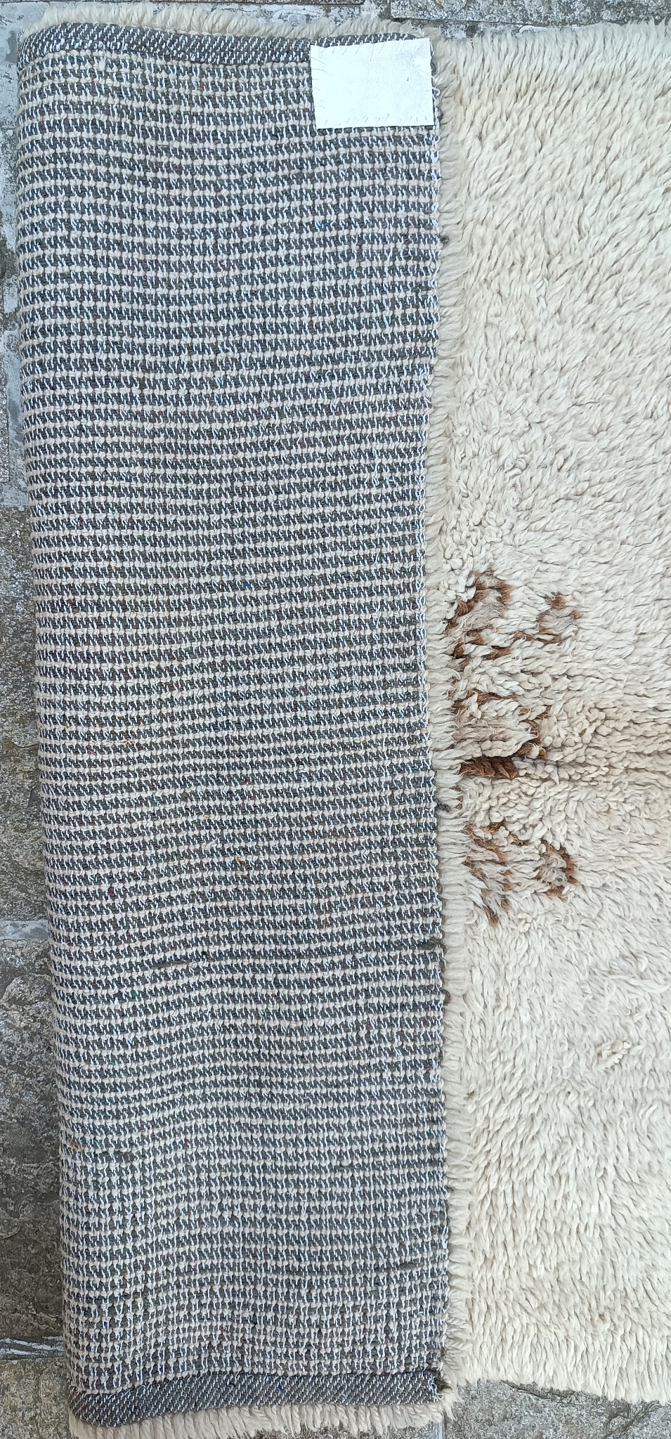 Reverse side of a vintage Bulgarian handwoven wool kitenik from the Vidin region, showing the woven foundation and cream long pile