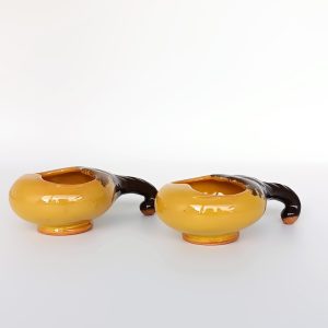 Pair of vintage ceramic Schnapspfeifle pipe-shaped liqueur cups in ochre yellow and dark brown glaze