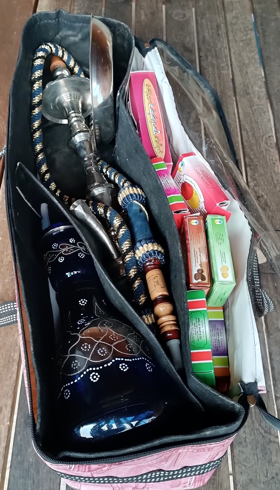 Open original travel case containing vintage Egyptian Yehia El Khawanky hookah components, decorated blue glass base, metal stem and braided hose